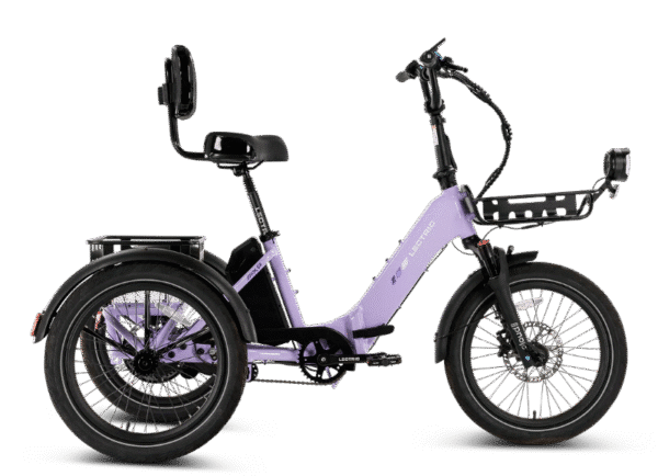 A lavender three-wheel electric bike with a rear cargo rack, backrest on the seat, and a black front basket, photographed against a white background.