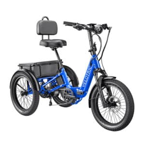 A blue electric tricycle with a padded seat and backrest, three wide tires, and a battery mounted behind the seat. The frame is labeled "Velotric." The trike is designed for comfortable and stable riding.