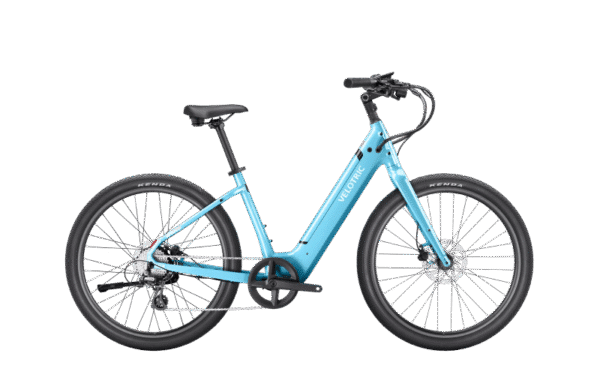 A light blue electric bicycle with a step-through frame, black saddle, black handlebars, and large black tires, shown from the side on a plain white background.