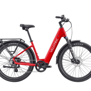 A red Velotric electric bicycle with a step-through frame, black seat, rear rack, and wide black tires, shown in a side view on a white background.
