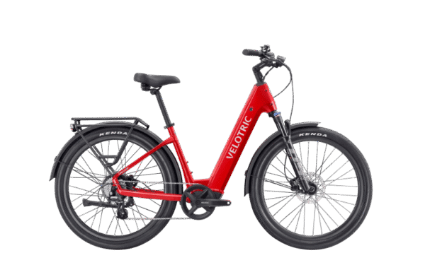 A red Velotric electric bicycle with a step-through frame, black seat, rear rack, and wide black tires, shown in a side view on a white background.