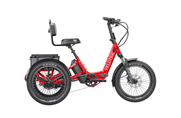 A red three-wheeled electric bike with a rear cargo rack, padded backrest, wide tires, and the brand name "Velotric" on the frame, shown in a side profile on a white background.